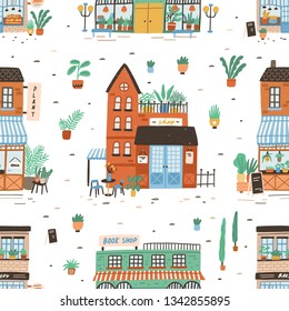 Seamless pattern with city buildings on white background. Backdrop with facades of bakery or bakeshop, book store, plant shop. Cute flat vector illustration for wrapping paper, textile print.