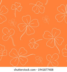 Seamless pattern with clover. The leaves of the clover. Contour background. White line. Orange pattern. Vector illustration. Stock vector.