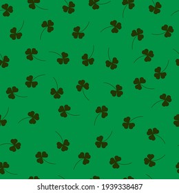 Seamless pattern with clover leaves on a green background
