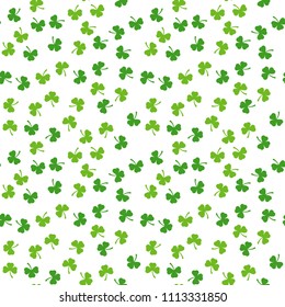 Seamless pattern of clover leaves. Random floral vector background. Green plant. Traditional Iraland holiday symbol. Saint Patric day. Lucky or fortune token. Summer coordinating ornament.