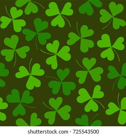 Seamless pattern with clover on a green background