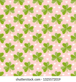 Seamless pattern with clover on a pink background with hearts, for St. Patrick's Day. Excellent design for packaging, wrapping paper, textile, clothes and etc.
