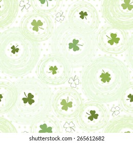 Seamless pattern with clover on the  polka dots background 