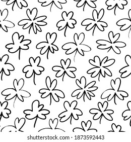 Seamless pattern with clovers for St Patrick's Day. Hand drawn vector shamrock ink illustration. Four and three black leaf clover. Black brush leaves and twigs. Abstract plant motif in linear style