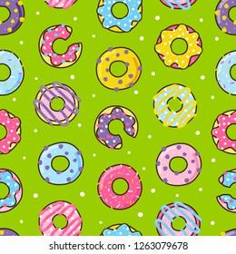 Seamless pattern with color donuts on green