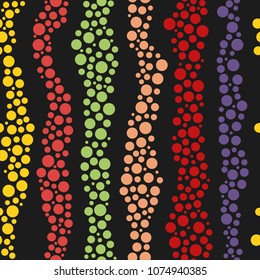seamless pattern of colored circles on a dark background