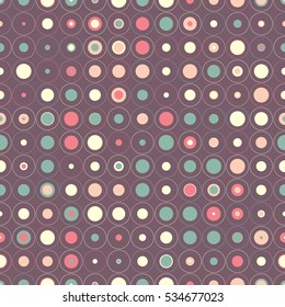 Seamless pattern of colored circles on a dark background. Optical illusion of motion.