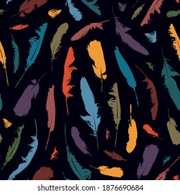 Seamless pattern with colored feathers on a black background. Vector repeating background with bird feathers. Suitable for wallpaper, wrapping paper, fabric, textiles