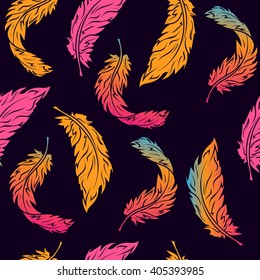 Seamless pattern with colored feathers on a dark blue background. Vector illustration.