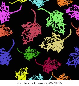 Seamless pattern of colored floral motif,maple leaves on a black   background. Hand drawn. Autumn theme.