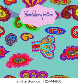 Seamless pattern of colored floral motifs, label on a light azure    background. Hand drawn.