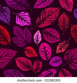 Seamless pattern with colored leaves on a dark purple background