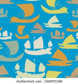 Seamless pattern of colored ships silhouettes on a blue background.
