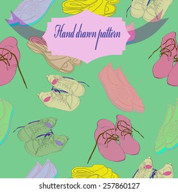 Seamless pattern of colored shoe, label on a  pale green    background. Hand drawn.