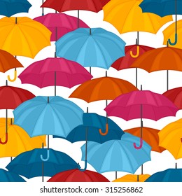 Seamless pattern with colored umbrellas for background design.