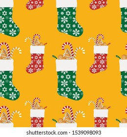 Seamless pattern of colorful Christmas socks with gifts.  Red and green stockings with a festive snow flake design. Good for festive decor, gift wrapping and textiles. Candy cane, ginger bread cookies