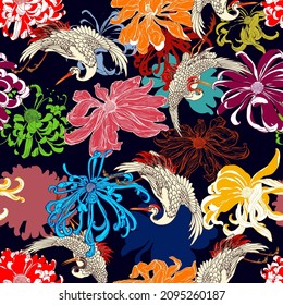 Seamless pattern of colorful chrysanthemums and cranes flying upon on black background.