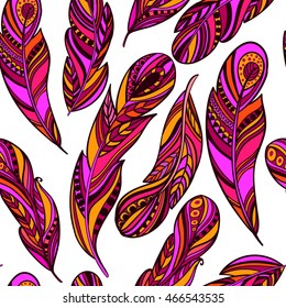 Seamless pattern with colorful feathers in the ethnic style on a white background. Vector illustration.