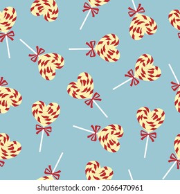 Seamless pattern of colorful heart shaped lollipop with pink bow on blue background. Background for Valentine holiday design, birthday party, invitation. Vector illustration