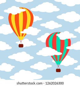 Seamless pattern with colorful hot air balloons and clouds on a blue background.