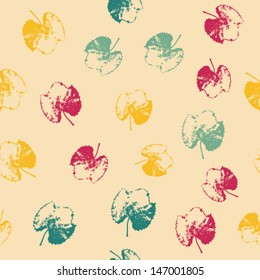 Seamless pattern with colorful leaves on a light background