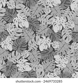 Seamless pattern of colorful leaves on a dark gray background. Presented through the close positioning of leaves together as one wall. This format is suitable for printing on fabric, textile and paper