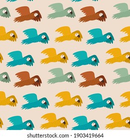 Seamless pattern with colorful parrots. Modern color palette - goldenrod, jade, copper. Light beige background. Trendy 
Ara parrot birds flying. Brown, yellow, bright green blue. Repeated fauna.