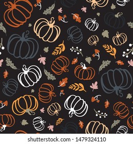 Seamless pattern of colorful pumpkins with maple leaves on dark background.