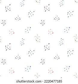 Seamless pattern of colorful specks on white background.