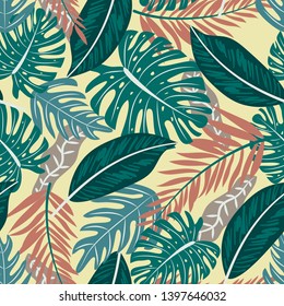 Seamless pattern with colorful tropical plants on yellow background. Vector design. Flat jungle print. Floral background.