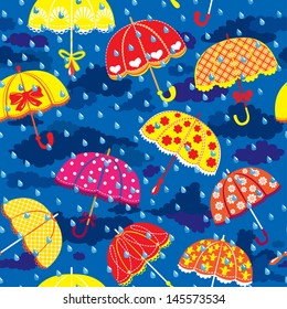 seamless pattern with colorful umbrellas, clouds and rain drops on blue sky background. 