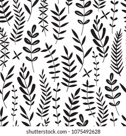 Seamless pattern consisting of black silhouettes of branches and leaves