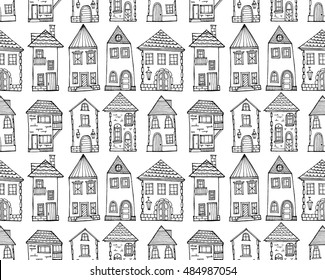 Seamless  pattern consisting from facades of ancient houses. Old city. Drawn by hand. White contours against a dark background. Black-and-white pattern.Black-and-white pattern.