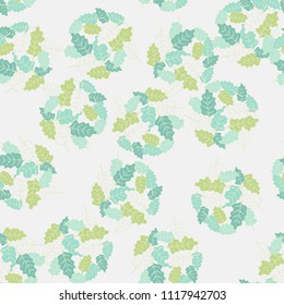 A seamless pattern consisting of groups of multicolored oak leaves. Against the background of the picture there is a network consisting of mutually perpendicular ovals.