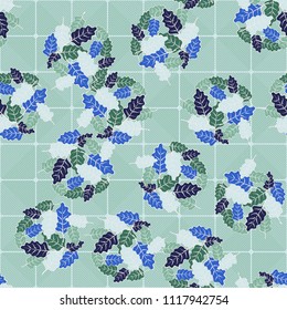 A seamless pattern consisting of groups of multicolored oak leaves. On the background of the picture there is a network consisting of diagonally striped rounded squares.