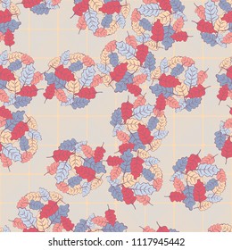 A seamless pattern consisting of groups of multicolored oak leaves. On the background of the picture there is a network consisting of diagonally striped rounded squares.
