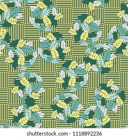 A seamless pattern consisting of groups of multicolored oak leaves. The background of the picture is the grid composed of squares consisting of mutually perpendicular segments.