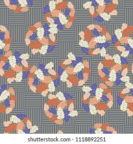 A seamless pattern consisting of groups of multicolored oak leaves. The background of the picture is the grid composed of squares consisting of mutually perpendicular segments.