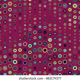Seamless pattern. It consists of geometric elements having a round shape, different size and color. On a red background. Useful as design element for texture and artistic compositions.