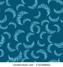 The seamless pattern consists of manually drawn crescent moons. The blue crescent is chaotically scattered across the blue field to form a beautiful pattern for children's room wallpaper or wrapping