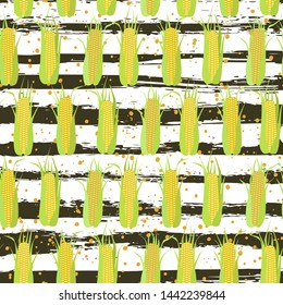 Seamless pattern of corn cobs on the background of grunge strips and scattered grains of corn. Summer, autumn harvest. Design for textile, fabric,  packaging, wallpaper.