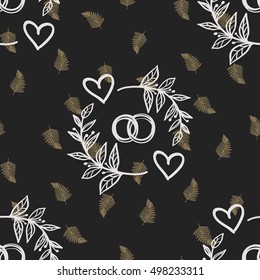 Seamless pattern with couple of rings and golden fern leaf. Decorative design for eco forest wedding or autumn celebrations. Rustic floral symbols and elements on black chalkboard.