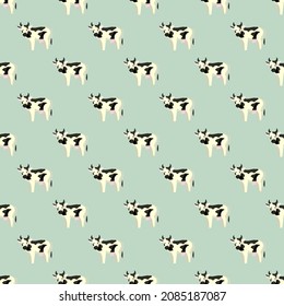 Una vaca sin foco en el fondo de la menta. Textura de animales de granja para cualquier propósito. Plantilla geométrica para el diseño de tela textil. Ornamento vectorial simple.