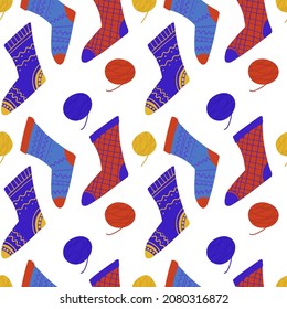 Seamless pattern of cozy knitted socks. Vector background for wrapping paper and different textile design