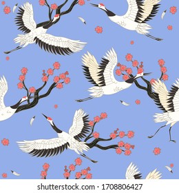 Seamless pattern with cranes birds and sakura. Vector graphics