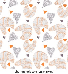 Seamless pattern with croissants, hearts and French text that says Croissant with butter. Vector file contains the pattern swatch!