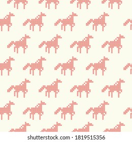 The seamless pattern with the cross-stitch red horses on the beige background.