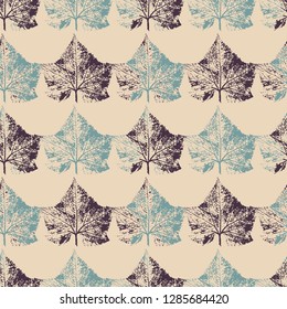 Seamless pattern of cucumber leaf prints in dark and blue on beige background.