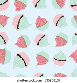 Seamless pattern with cupcakes on light blue background.Vector sweets 