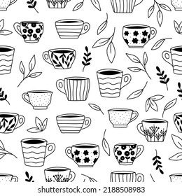 Seamless pattern with cups and tea leaves. Doodle hand drawn mugs and plants. Black and white vector illustration.